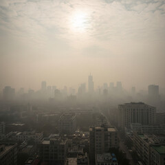 Fototapeta premium smog covered city skyline with faded sunlight representing air pollution climate crisis and environmental degradation concept