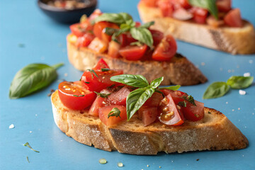 Bruschetta with Tomatoes and Basil on Blue Background