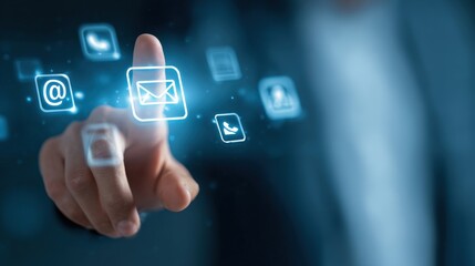 A person is pointing at a screen with a blue background and a large blue circle with a white letter "e" in the middle. The circle is surrounded by other icons, including a phone, a computer