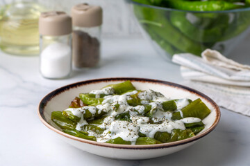From Turkish cuisine, served with yogurt sauce on fried green peppers. Turkish name; Yogurt soslu...
