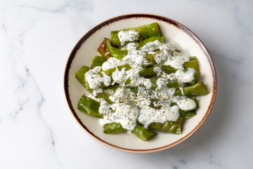 From Turkish cuisine, served with yogurt sauce on fried green peppers. Turkish name; Yogurt soslu biber kizartmasi