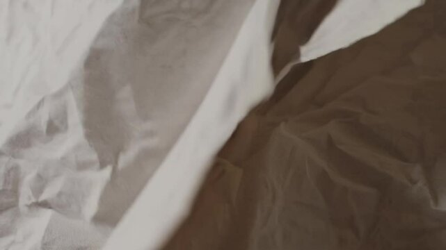 Animated Crinkled Paper Texture Loop with Gentle Movement, Visible Wrinkles, Creases, and Worn Edges, Shadows in Folds, Authentic Tactile Appearance, Smooth Flow
