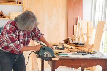 Elderly lifestyle working after retirement concept, healthy senior carpenter happy working in...