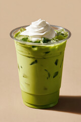 Iced matcha latte with soft cream topping in clear plastic cup on beige background, refreshing and creamy drink