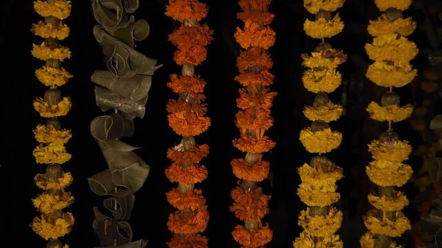 Beautiful marigold flower garland with green mango leaves hangs as a traditional decorative border in the background, symbolizing Indian culture, religion, and festive celebrations like Diwali, Pongal