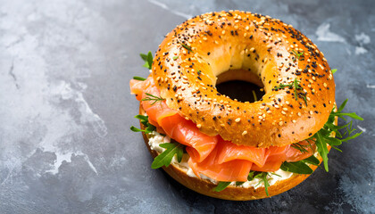Toasted Salmon Cream Cheese Bagel with Capers and Parsley on Slate Board