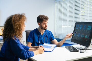 Male doctor explains health scan results to female patient using a computer screen. Concept of diagnosis, health tech, medical consultation