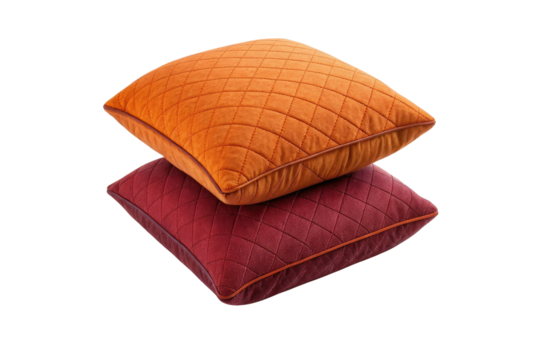 Stacked square pillows in orange and red with a quilted pattern on a black background image