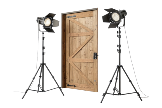 A studio setup featuring a wooden door flanked by two professional lighting equipment on tripods