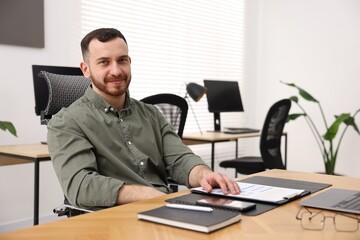 Obraz premium Handsome man working at desk in office. Space for text