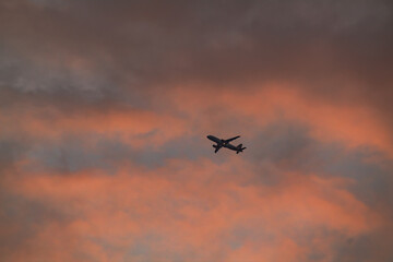 Airplane Silhouette Flying Across a Dramatic Sunset Sky
