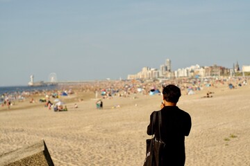 Man taking photo of a full beach