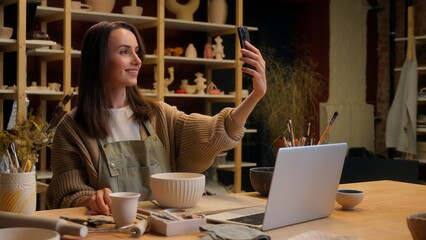 Artist woman creator sculptor art designer potter small business owner saleswoman Caucasian girl blogger influencer social media phone blog video sale crockery handmade craft store pottery workshop