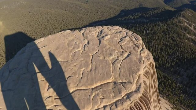 Breathtaking Aerial Shot of Devils Tower National Monument with Surrounding Plains and ForestsVideo Background