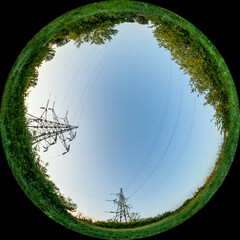 Electric power transmission in non-urban areas. Countryside with High-voltage pylons. HDR photo in fulldome format taken through a circular fisheye lens. Wide angle of view 180 degrees