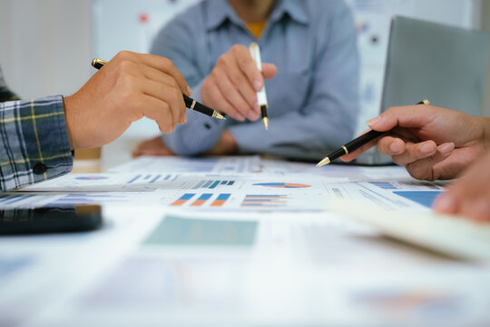 A professional business team collaborates around a conference table, analyzing charts, discussing strategies, reviewing reports, and planning innovative solutions to drive growth, efficiency, and long