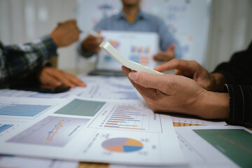 A professional business team collaborates around a conference table, analyzing charts, discussing strategies, reviewing reports, and planning innovative solutions to drive growth, efficiency, and long