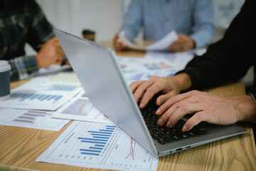 Fototapeta premium A professional business team collaborates around a conference table, analyzing charts, discussing strategies, reviewing reports, and planning innovative solutions to drive growth, efficiency, and long