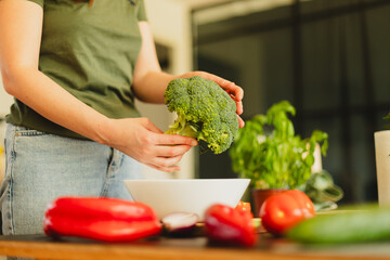 Woman cutting fresh vegetables in the kitchen. Healthy cooking, food preparation and lifestyle...