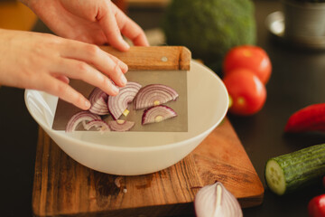 Woman cutting fresh vegetables in the kitchen. Healthy cooking, food preparation and lifestyle...
