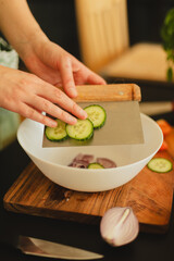 Woman cutting fresh vegetables in the kitchen. Healthy cooking, food preparation and lifestyle concept

