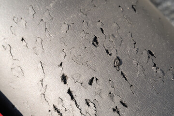 Close-up shot of black foam full of scratches. Textured background of black foam scratched by cat. Abstract black backgrounds. Soft foam full of wrinkles and scratches. Negative space