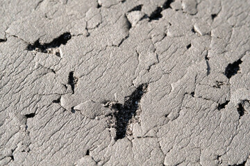 Close-up shot of black foam full of scratches. Textured background of black foam scratched by cat. Abstract black backgrounds. Soft foam full of wrinkles and scratches. Negative space