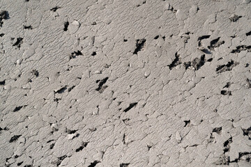 Close-up shot of black foam full of scratches. Textured background of black foam scratched by cat. Abstract black backgrounds. Soft foam full of wrinkles and scratches. Negative space