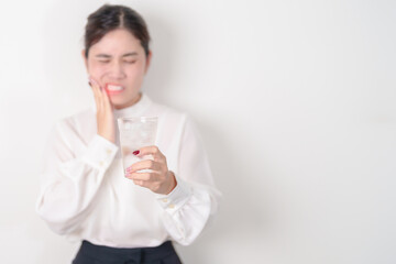 Business woman having toothache and pain after drink ice water for concept of Teeth Sensitive to...