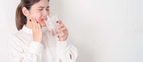 Business woman having toothache and pain after drink ice water for concept of Teeth Sensitive to...