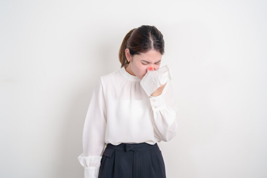 business woman blowing her nose with tissue for concepts of Common Cold, Influenza, Flu, Hay, Fever, Covid 19, Respiratory Infection, Sinusitis, Allergic Rhinitis, Allergy, Medical and health care
