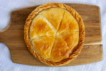 Delicious cooked cheese pie showing delicious cheese pie and crust on a wooden board.