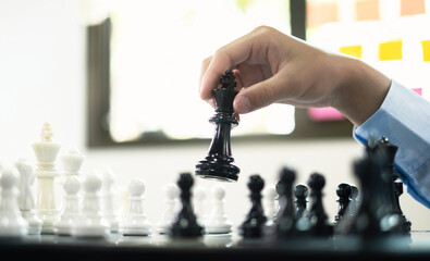 hand of businessmen moving chess in competition shows leadership, followers and business success...