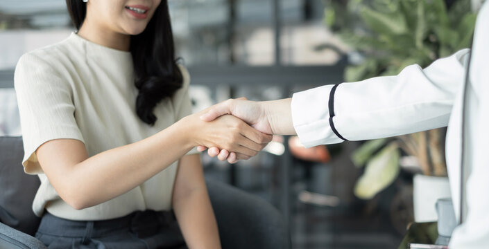 businesswoman shake hands after the meeting was successful and agreed upon