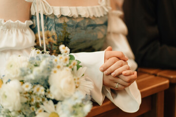 The bride's hands before the altar