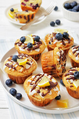 tasty blueberry muffins with lemon chocolate glaze