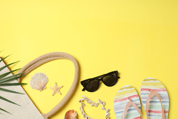Tropical vibes shot from above. Straw hat, sunglasses, pineapple, wicker bag, beach accessories on...