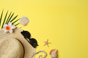 Tropical vibes shot from above. Straw hat, sunglasses, pineapple, wicker bag, beach accessories on...