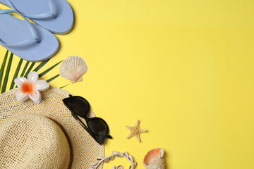 Tropical vibes shot from above. Straw hat, sunglasses, pineapple, wicker bag, beach accessories on...