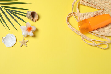 Tropical vibes shot from above. Straw hat, sunglasses, pineapple, wicker bag, beach accessories on...
