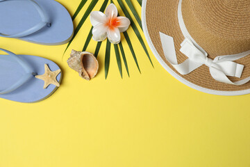 Tropical vibes shot from above. Straw hat, sunglasses, pineapple, wicker bag, beach accessories on...