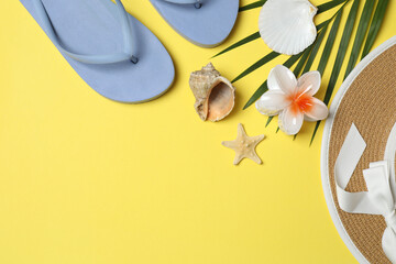Tropical vibes shot from above. Straw hat, sunglasses, pineapple, wicker bag, beach accessories on...