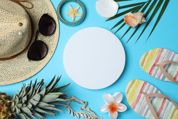 Tropical vibes shot from above. Straw hat, sunglasses, pineapple, wicker bag, beach accessories on...