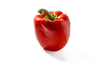 Juicy red bell pepper shown from an angle with droplets of water, set against a bright white backdrop. Emphasizes freshness and vibrant color.