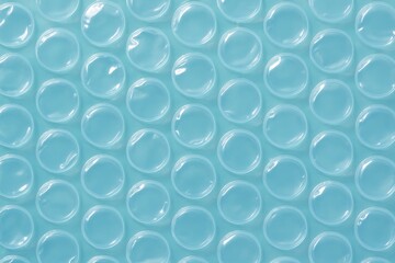 Glossy blue bubble wrap catches light, creating a calming and protective textured background ideal for e-commerce, packaging, or abstract graphic design.