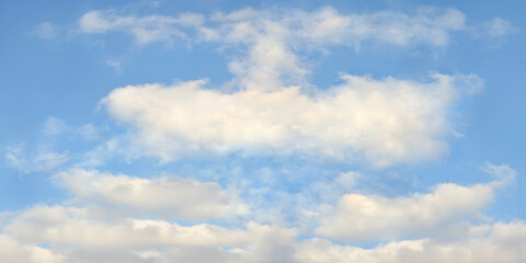 Cumulus clouds on the background of the blue sky. Horisontal sky with white cumulus clouds...