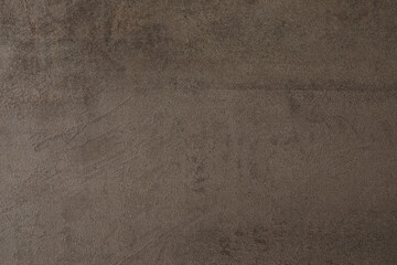 Art background of brown roughly plastered wall, copy space.