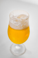 A bubbles in a glass of foamy beer on a white background. cooling drink. 
