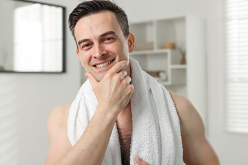 Portrait of smiling man after shaving at home