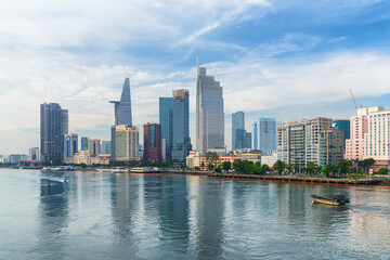Ho Chi Minh City skyline. Boats crossing the Saigon River